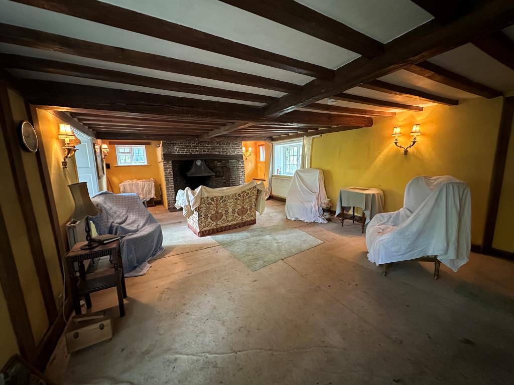 Lot: 107 - DETACHED PROPERTY IN GROUNDS OF 3.5 ACRES WITH OUTBUILDINGS, STABLES AND DILAPIDATED BARN - Living room with inglenook fireplace